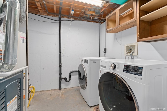 washroom featuring heating unit and washing machine and clothes dryer