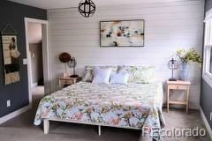 9092 Gray Ln, Conifer, CO 80433 - bedroom featuring baseboards and wooden walls
