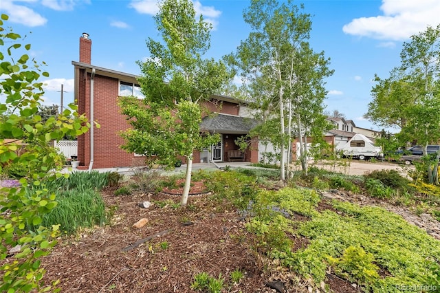2210 Miller St, Lakewood, CO 80215 - view of front of house featuring a chimney and brick siding