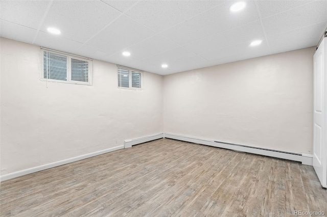 2210 Miller St, Lakewood, CO 80215 - finished below grade area with a drop ceiling, baseboards, visible vents, and wood finished floors