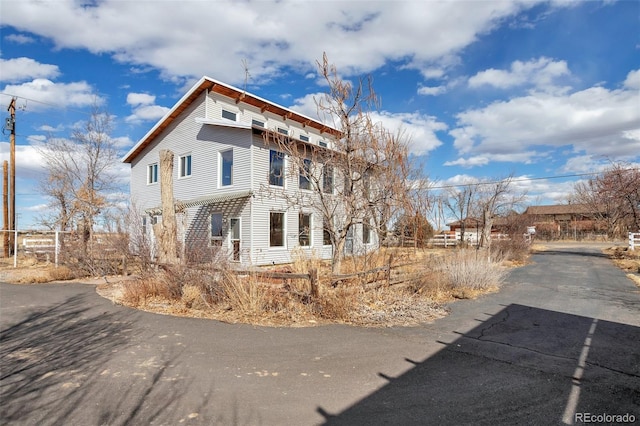 view of side of property featuring fence