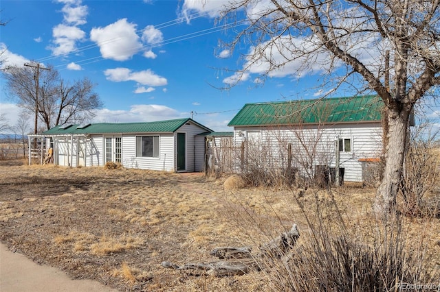 view of property exterior featuring metal roof