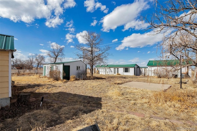 view of yard with fence and an outdoor structure