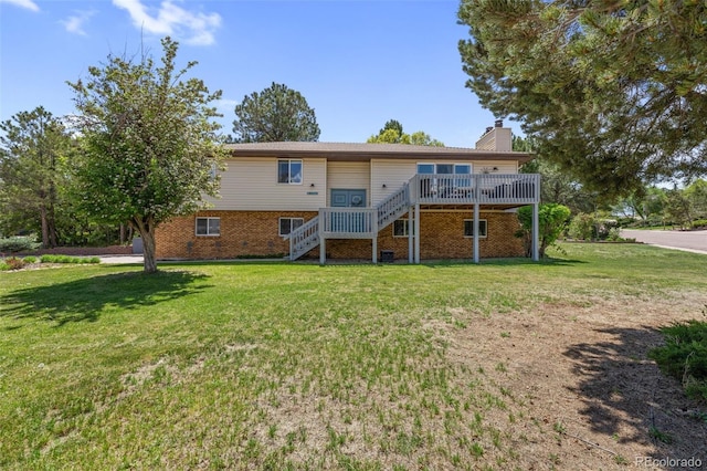 6170 Castlewood Ln, Colorado Springs, CO 80918 - back of house featuring stairway, a chimney, a wooden deck, brick siding, and a lawn