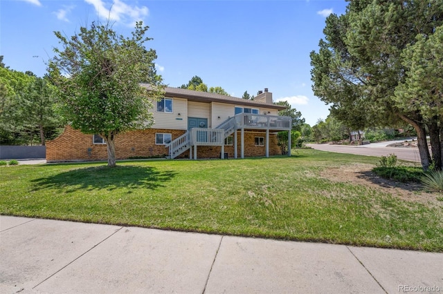 6170 Castlewood Ln, Colorado Springs, CO 80918 - view of front of home with stairs, a chimney, brick siding, a wooden deck, and a front lawn
