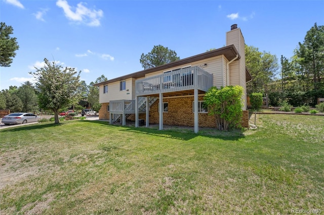 6170 Castlewood Ln, Colorado Springs, CO 80918 - rear view of property with a wooden deck, a chimney, stairway, a lawn, and brick siding