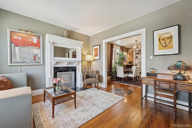 34 W Maple Ave, Denver, CO 80223 - living area featuring hardwood / wood-style floors, a chandelier, and a high end fireplace