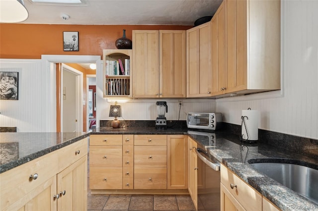 34 W Maple Ave, Denver, CO 80223 - kitchen featuring light brown cabinets, stainless steel dishwasher, light tile patterned floors, and dark stone counters