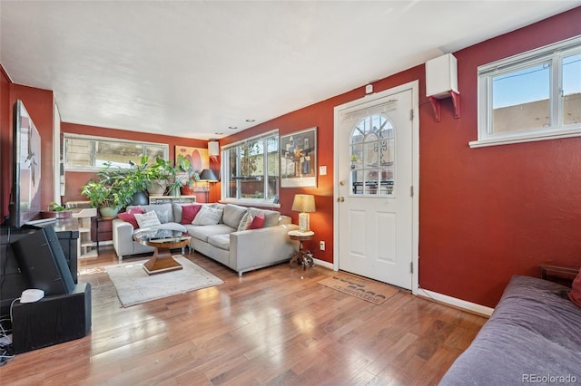 34 W Maple Ave, Denver, CO 80223 - living room featuring plenty of natural light and wood finished floors