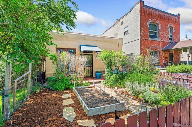 34 W Maple Ave, Denver, CO 80223 - view of front of property featuring a garden and brick siding