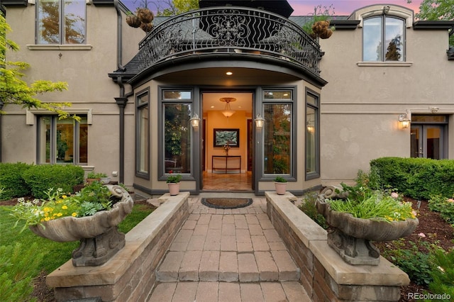 6901 E 12th Ave, Denver, CO 80220 - doorway to property with stucco siding and a balcony