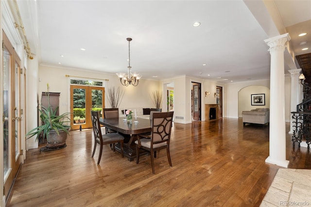 6901 E 12th Ave, Denver, CO 80220 - dining space featuring french doors, decorative columns, recessed lighting, a fireplace, and wood finished floors