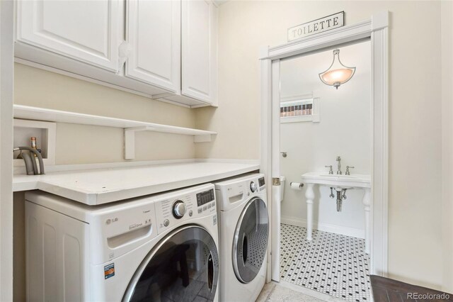 6901 E 12th Ave, Denver, CO 80220 - washroom with cabinet space, washer and dryer, and baseboards