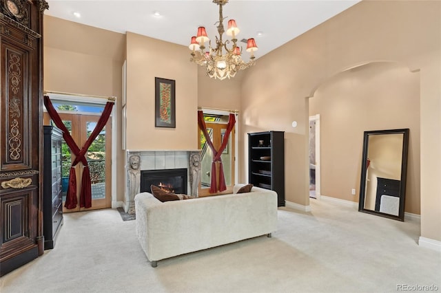 6901 E 12th Ave, Denver, CO 80220 - living room featuring light colored carpet, arched walkways, a chandelier, baseboards, and recessed lighting