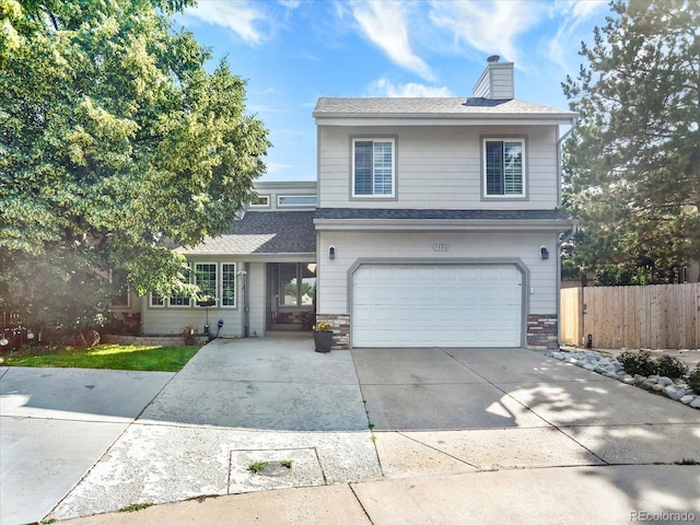 3596 S Telluride Way, Aurora, CO 80013 - traditional-style home with an attached garage, concrete driveway, a chimney, and a shingled roof