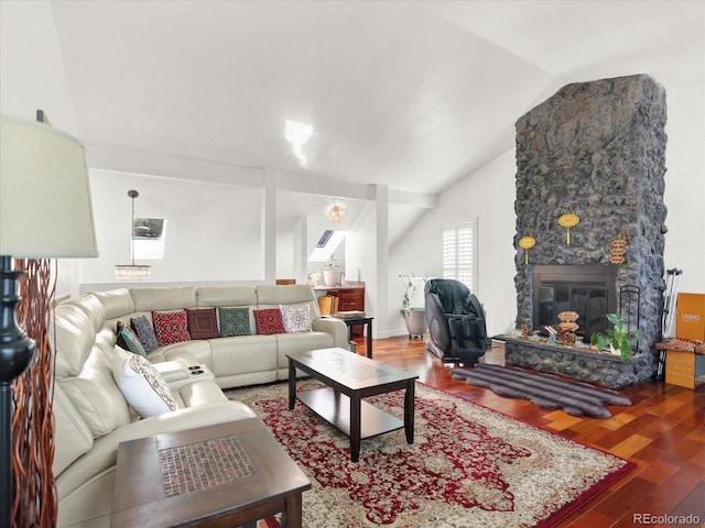 3596 S Telluride Way, Aurora, CO 80013 - living room featuring wood finished floors, vaulted ceiling, and a stone fireplace