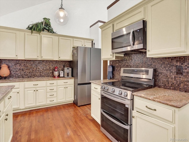 3596 S Telluride Way, Aurora, CO 80013 - kitchen with appliances with stainless steel finishes, tasteful backsplash, light wood-style floors, and pendant lighting