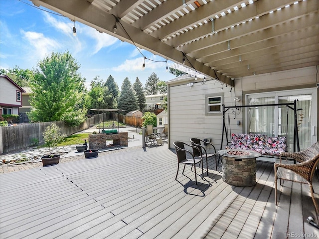 3596 S Telluride Way, Aurora, CO 80013 - wooden deck featuring a fire pit, a fenced backyard, a pergola, and a baseboard radiator