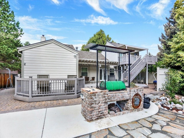 3596 S Telluride Way, Aurora, CO 80013 - rear view of house with a chimney, a patio area, stairway, a wooden deck, and a shingled roof