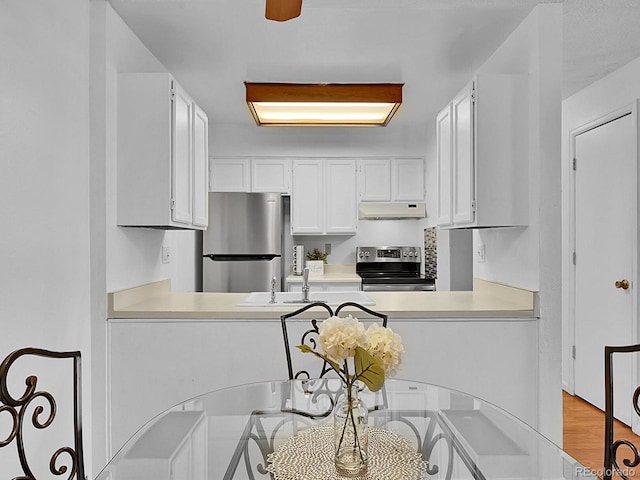 kitchen featuring sink, light hardwood / wood-style flooring, white cabinets, and appliances with stainless steel finishes