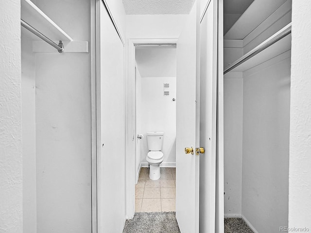 bathroom featuring tile patterned floors and toilet