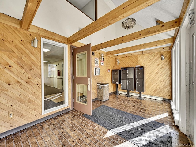 interior space with vaulted ceiling with beams and a mail area