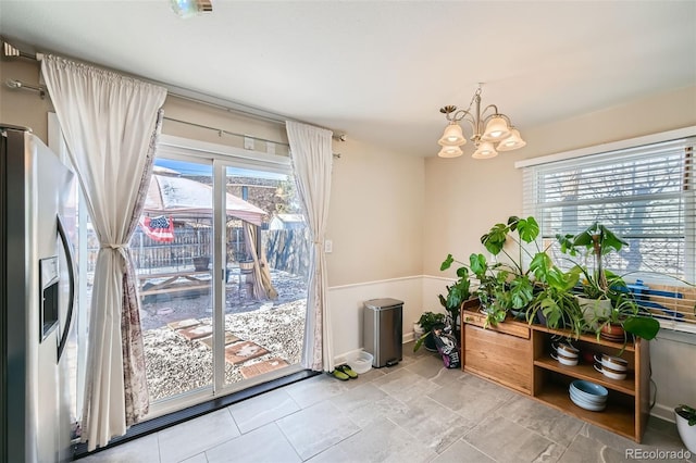 entryway featuring plenty of natural light and a notable chandelier