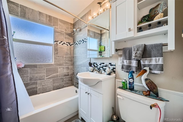 full bathroom featuring shower / bath combo, a wealth of natural light, vanity, and toilet