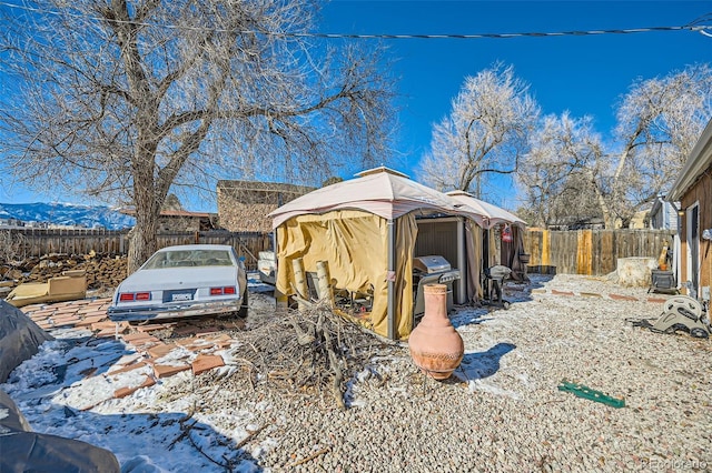 view of snowy exterior featuring a gazebo and a mountain view