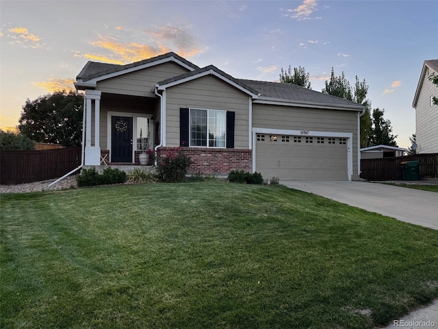 view of front of home featuring a garage and a lawn