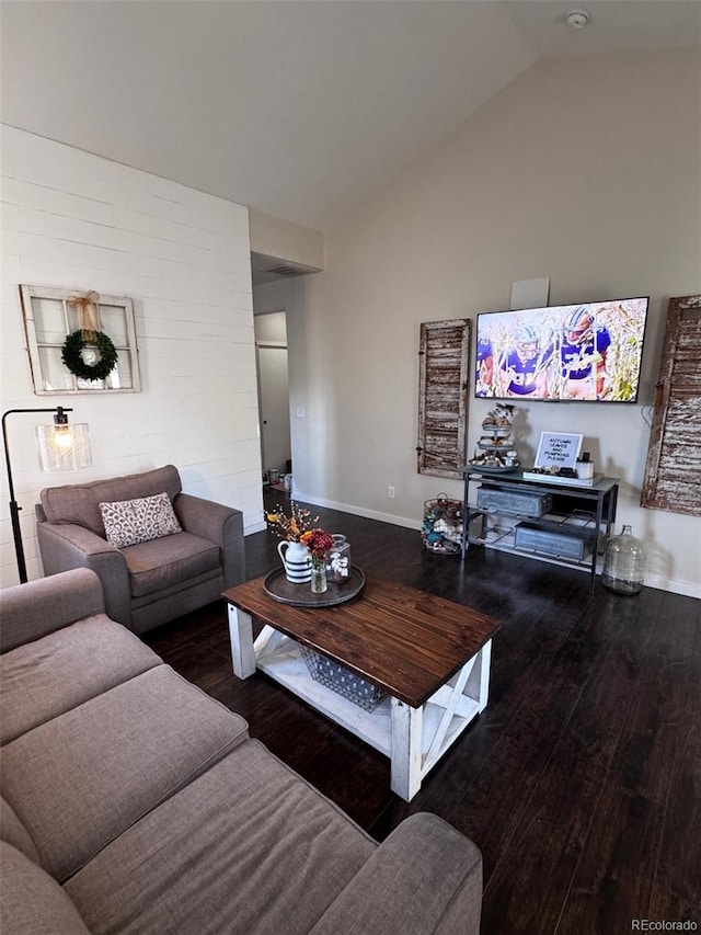 living room featuring hardwood / wood-style flooring and vaulted ceiling