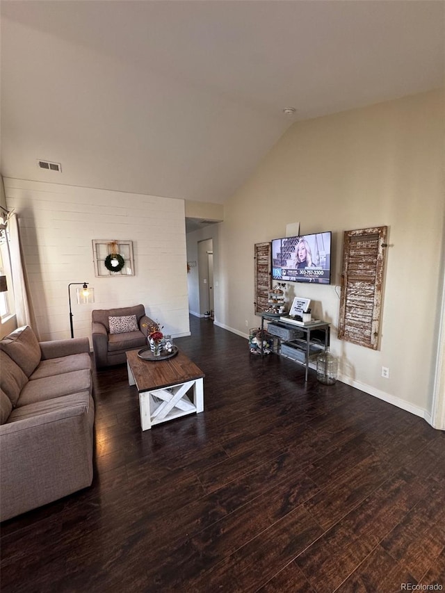 living room featuring lofted ceiling and dark hardwood / wood-style flooring