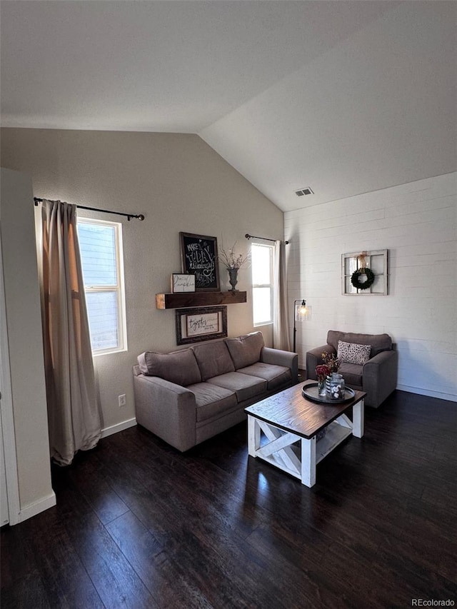 living room with lofted ceiling, dark hardwood / wood-style floors, and a wealth of natural light