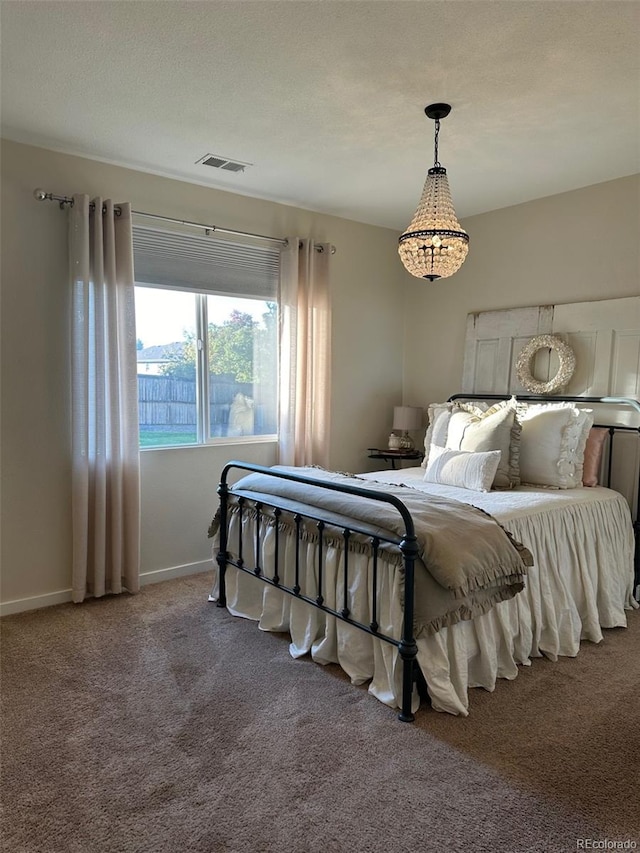 carpeted bedroom featuring a textured ceiling