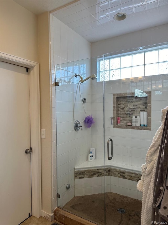 bathroom featuring a shower with shower door