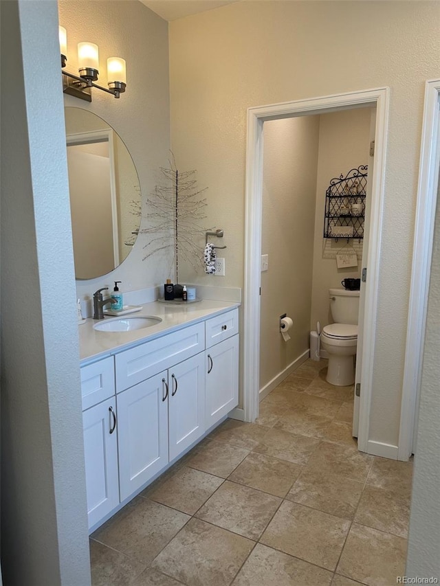 bathroom with vanity and toilet