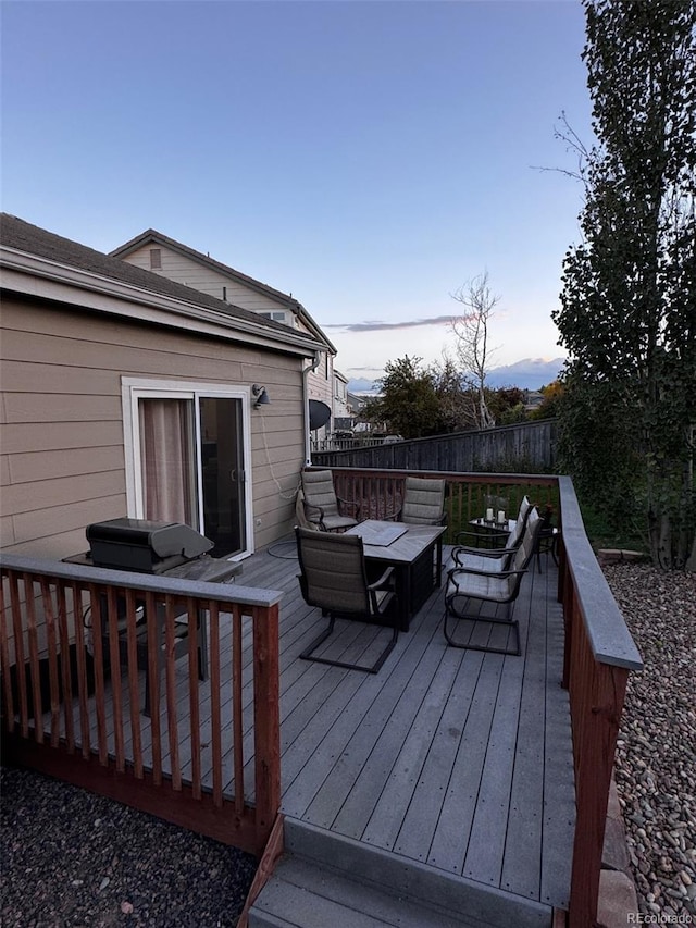 deck at dusk with outdoor lounge area