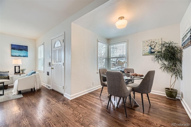 dining space with dark hardwood / wood-style floors