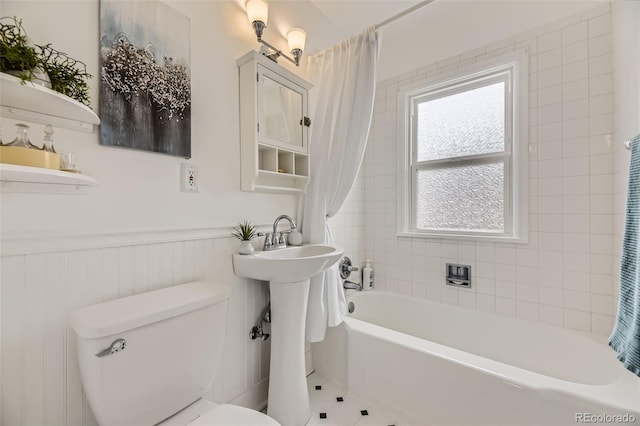 bathroom with tile patterned floors, toilet, and shower / bathtub combination with curtain