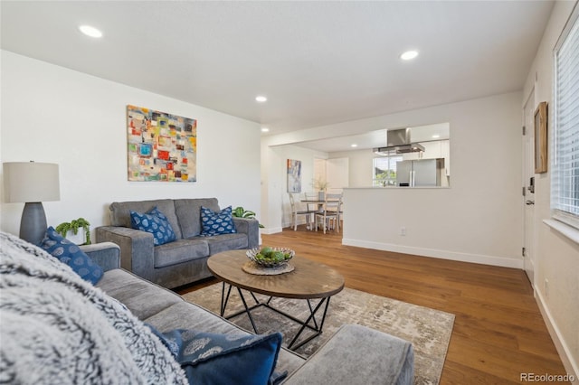 6193 Holland St, Arvada, CO 80004 - living room featuring wood finished floors, recessed lighting, and healthy amount of natural light