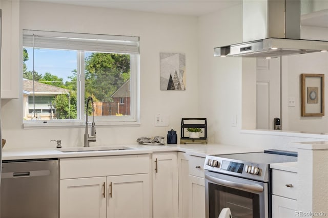 6193 Holland St, Arvada, CO 80004 - kitchen featuring appliances with stainless steel finishes, extractor fan, white cabinets, and light countertops