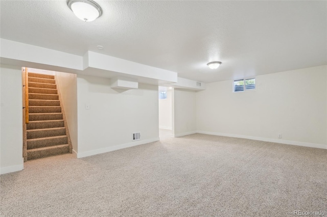 6193 Holland St, Arvada, CO 80004 - basement with carpet, stairs, and a textured ceiling