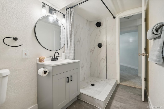 6193 Holland St, Arvada, CO 80004 - full bathroom with a tile shower, vanity, and a textured wall
