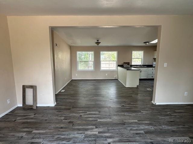 13193 E US Highway 160, Alamosa, CO 81101 - unfurnished living room with dark wood finished floors and baseboards