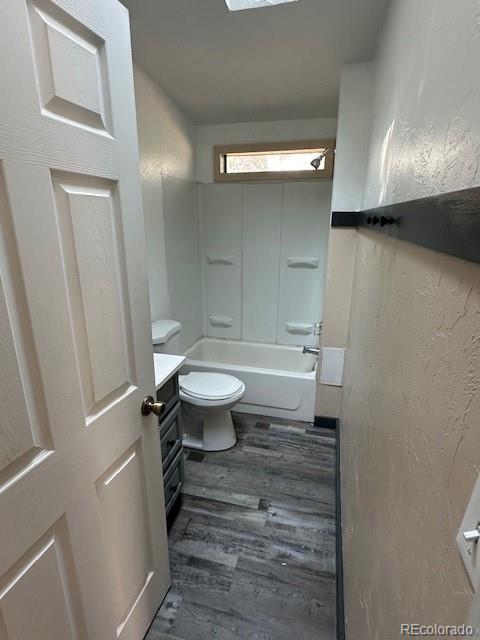 13193 E US Highway 160, Alamosa, CO 81101 - full bathroom featuring wood finished floors, vanity, and bathing tub / shower combination