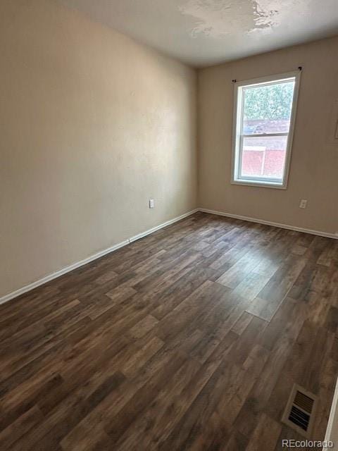 13193 E US Highway 160, Alamosa, CO 81101 - spare room with dark wood-style flooring and baseboards