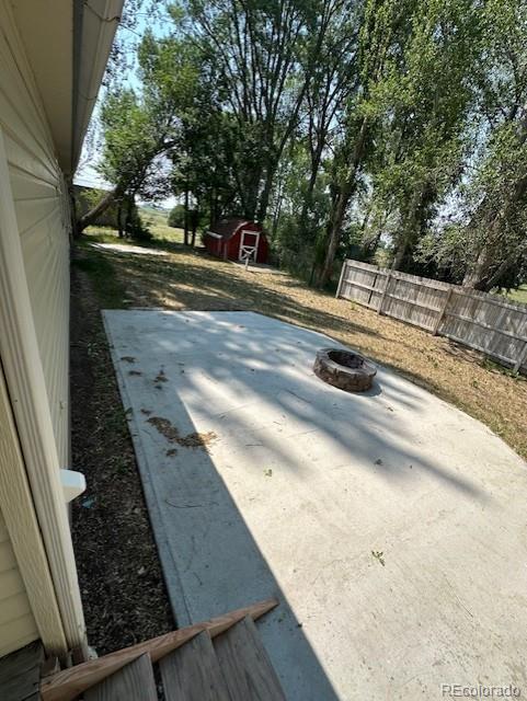13193 E US Highway 160, Alamosa, CO 81101 - view of patio / terrace with a fire pit and a shed