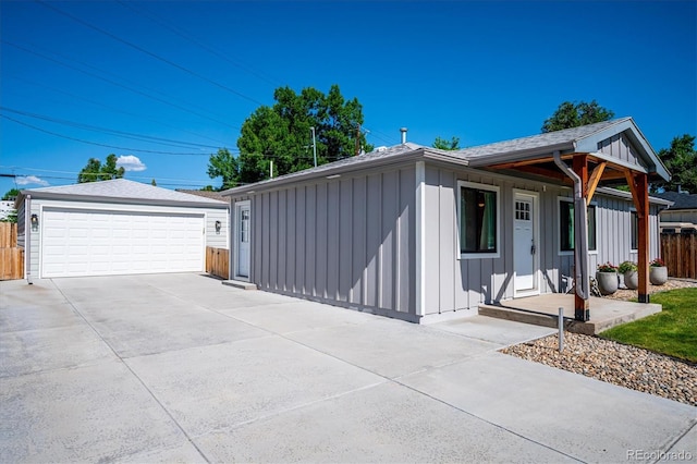 3995 Nelson St, Wheat Ridge, CO 80033 - view of front of home featuring board and batten siding, a detached garage, and an outdoor structure