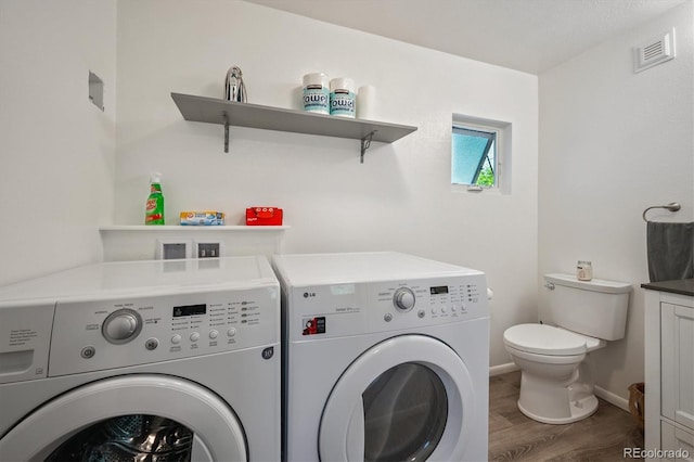 3995 Nelson St, Wheat Ridge, CO 80033 - laundry room featuring washing machine and dryer and wood finished floors