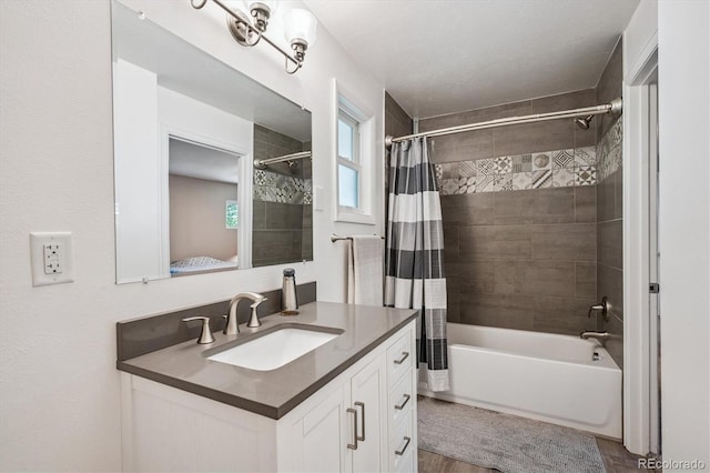 3995 Nelson St, Wheat Ridge, CO 80033 - ensuite bathroom featuring vanity, shower / bath combo, and wood finished floors